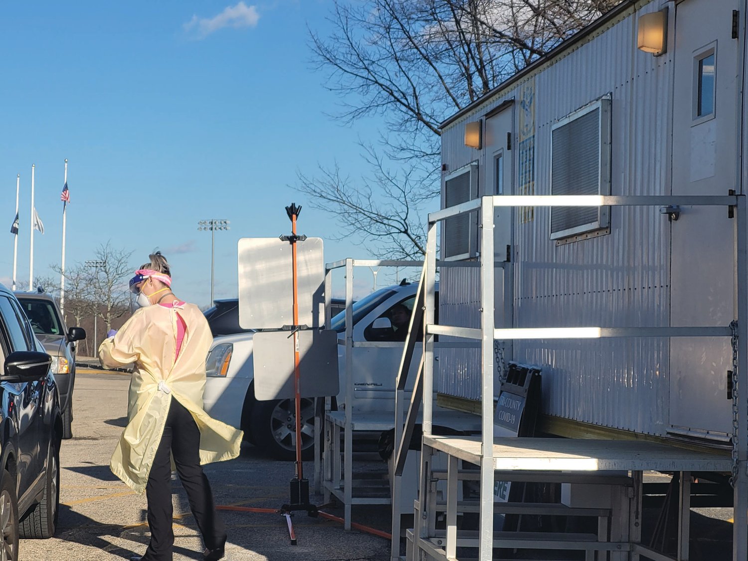 ULTIMATE TEST: Jessica Gormley, Practice Manager for Tri-County Community Action Agency, at right, gave Anthony Meleo, of Johnston, a PCR test for COVID-19 from the free testing trailer stationed in the Johnston High Parking lot.